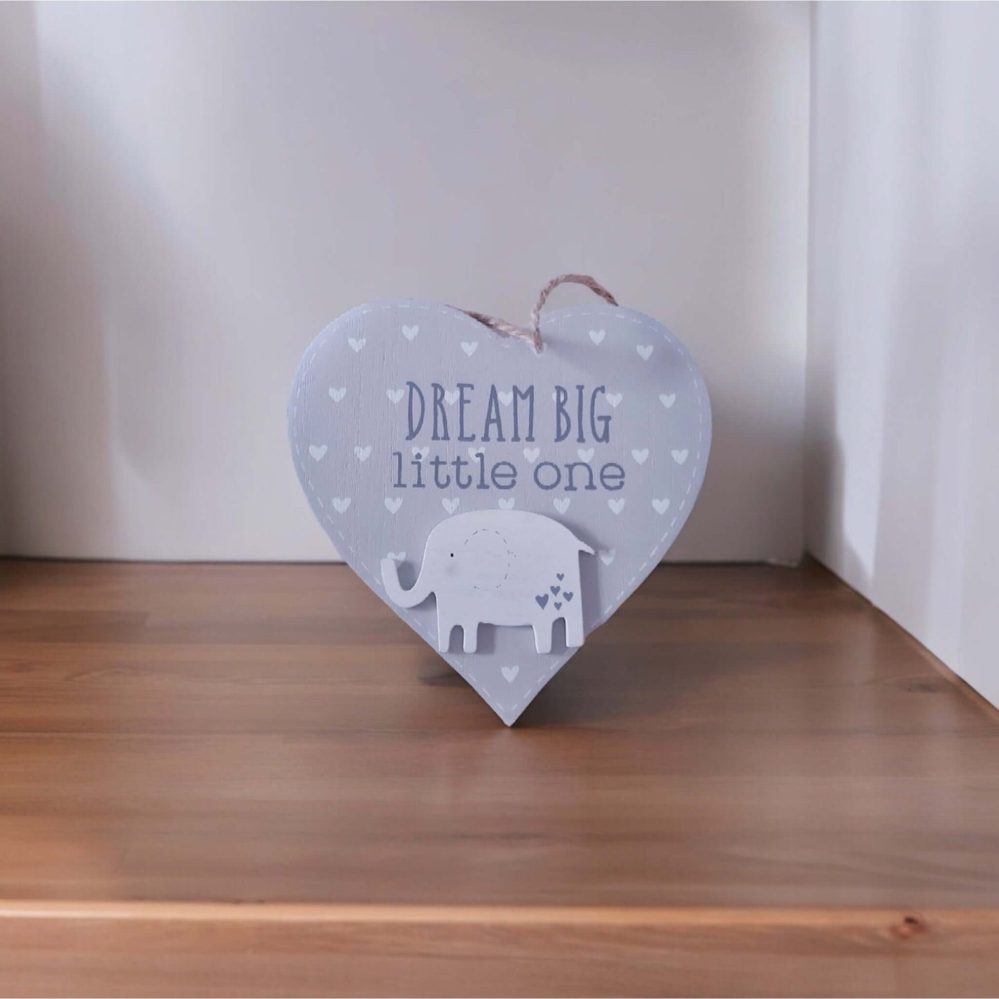 A grey wooden hanging heart adorned with a delightful elephant and the inspiring message 'Dream Big Little One'
From Wickerhearts gift collecton.