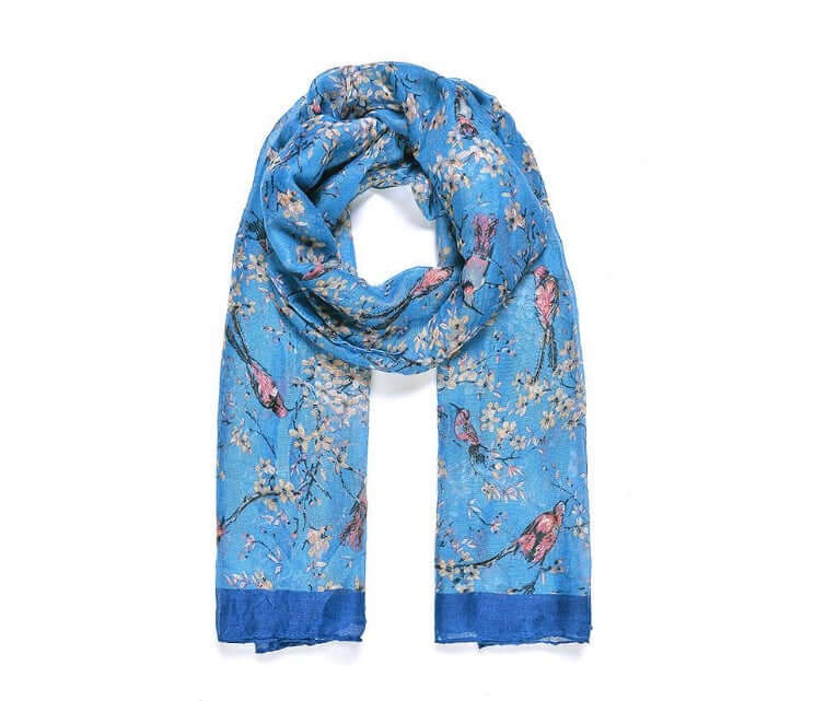 View of blue bird print patterned scarf, with shades of pink and neutral coloured flowers. From Wickerhearts gift collection.