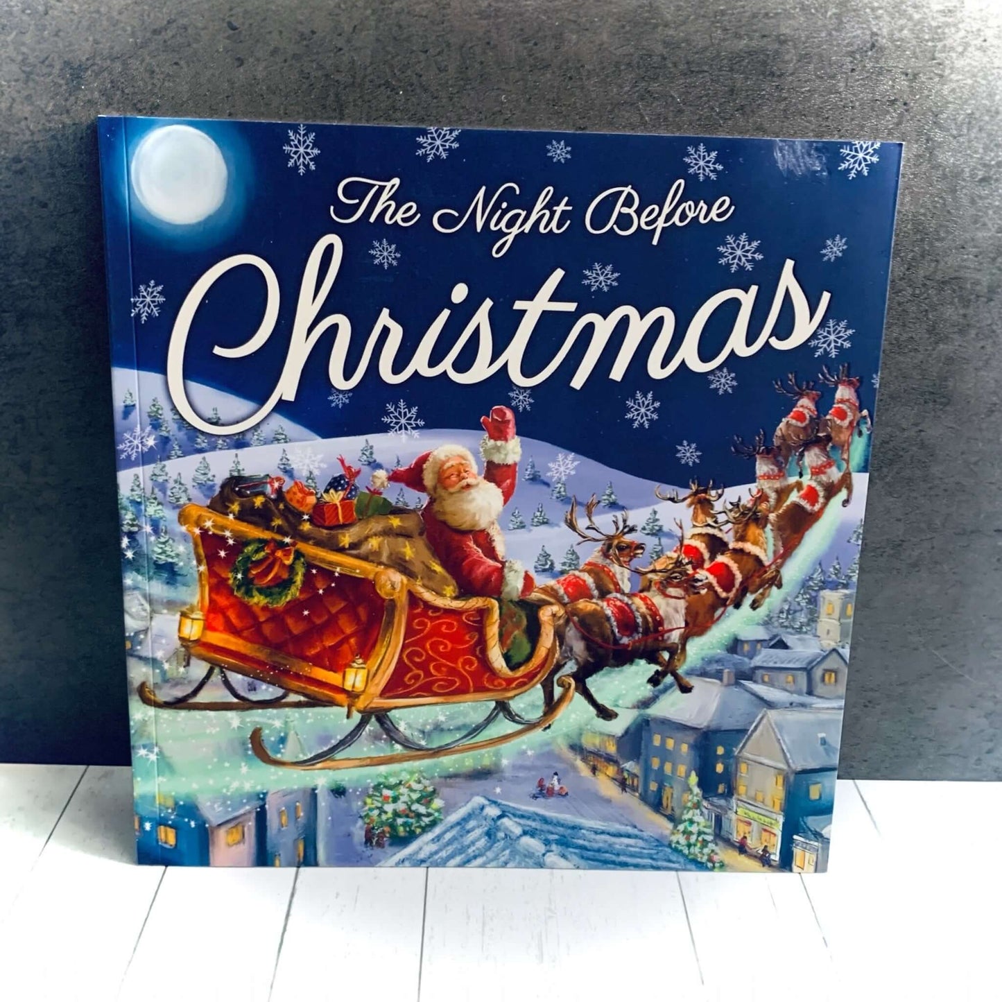 Image of Santa and his sleigh with reindeers on a blue background, for the children's story book The Night Before Christmas. From Wickerhearts Christmas gift collection.