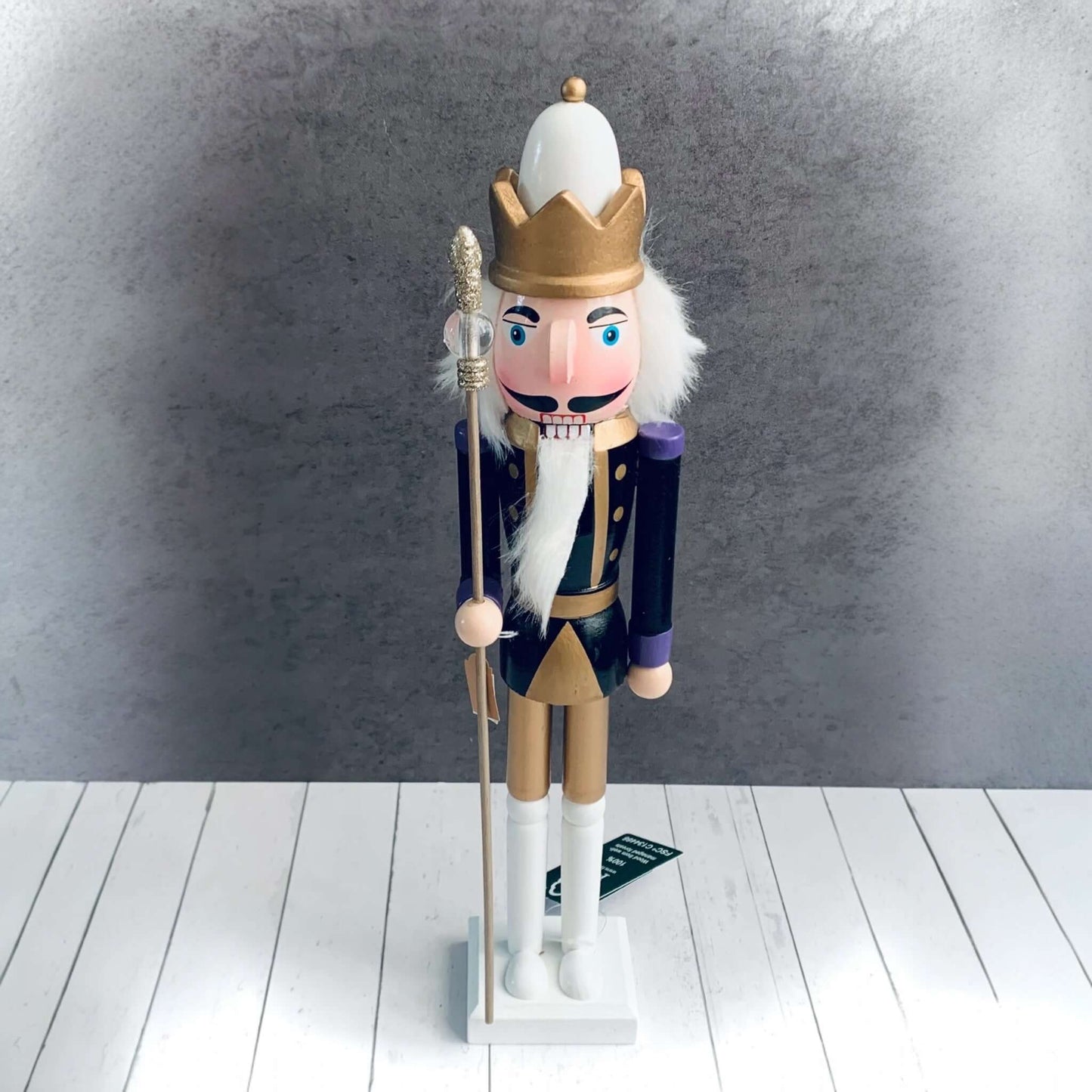 Large black, white and gold Nutcracker with crown type hat and holding long staff. From Wickerhearts Christmas gift collection.