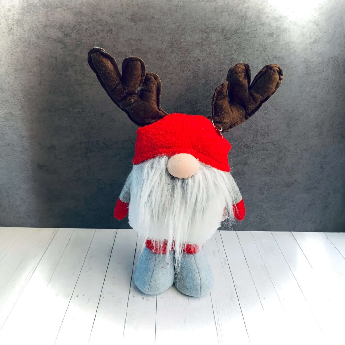 Red and grey fabric Gonk with brown antlers with legs not extended in shorter position. From Wickerhearts Christmas gift collection.