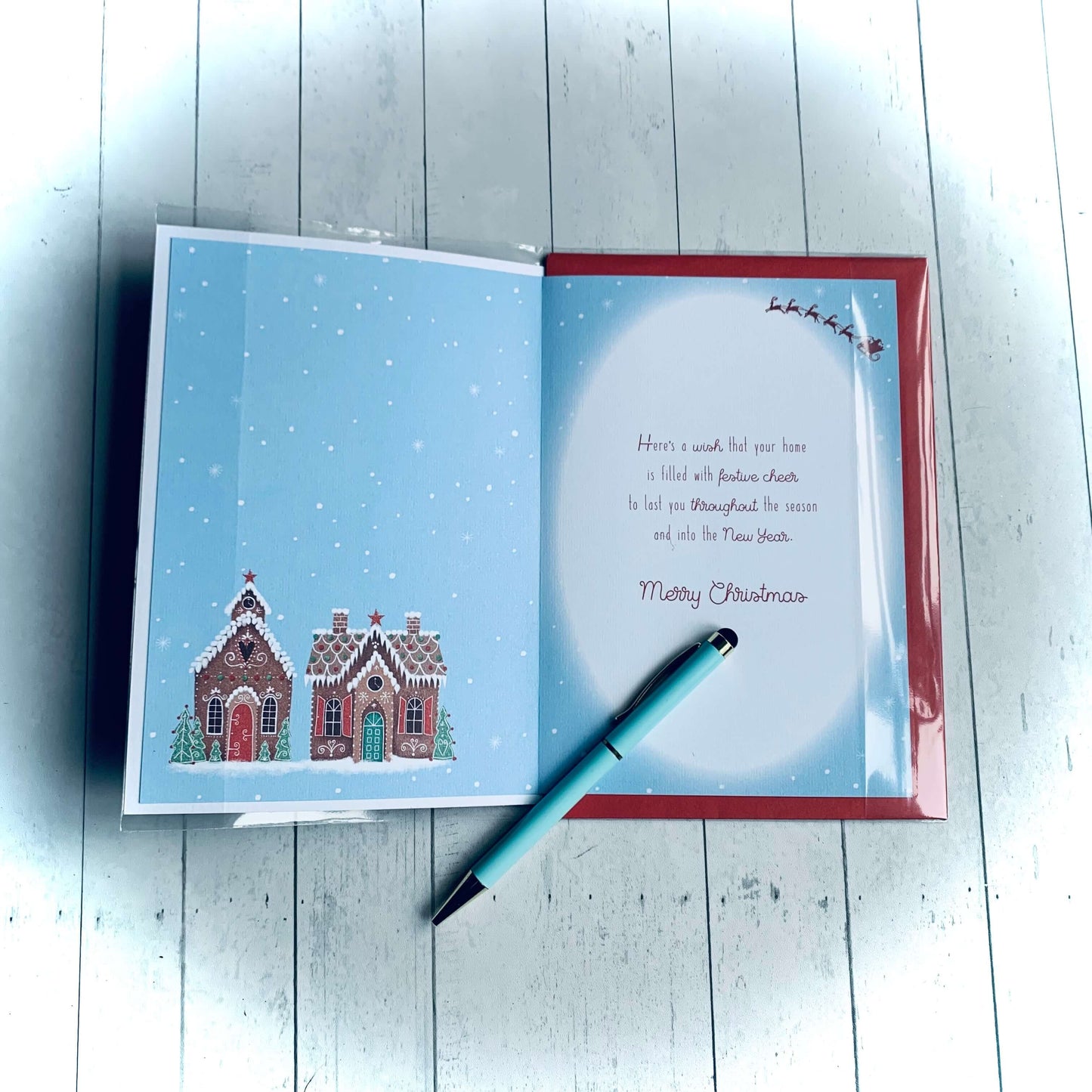 Inside of Christmas 'Our house to yours' card with replicated house picture from front and Christmas wishes. Red envelope. From Wickerhearts Christmas card and gift collection.