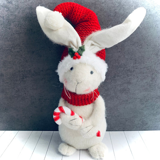 Large festive white fabric rabbit, with red hat and scarf, holding a candy cane for  touch of festive fun. From Wickerhearts Christmas gift collection.