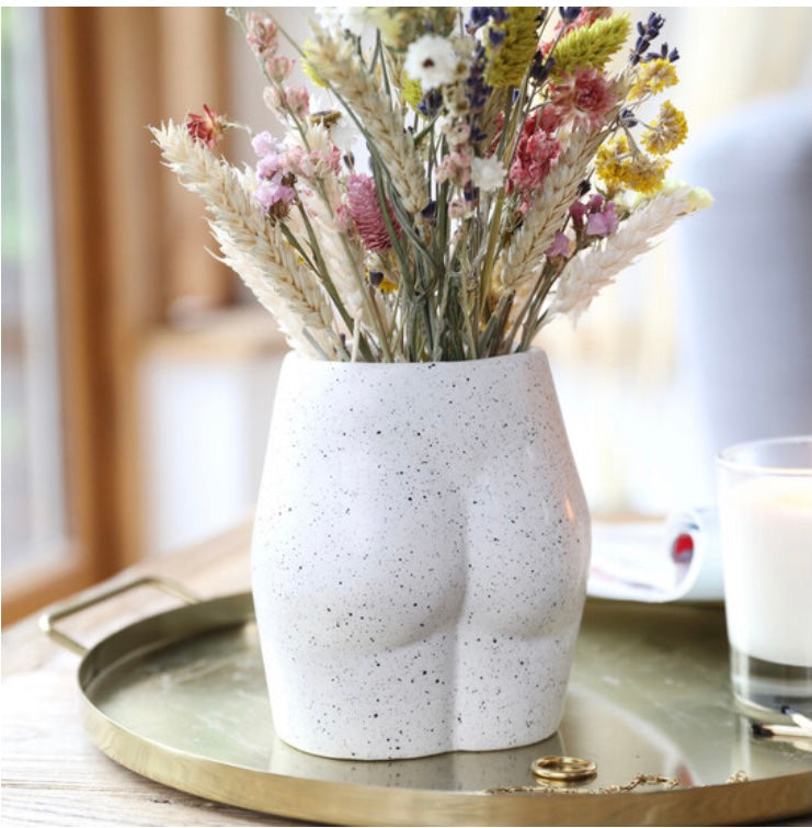 Cheeky white, bottom shaped ceramic vase, with colourful display of dried flowers. From Wickerhearts gift collection.