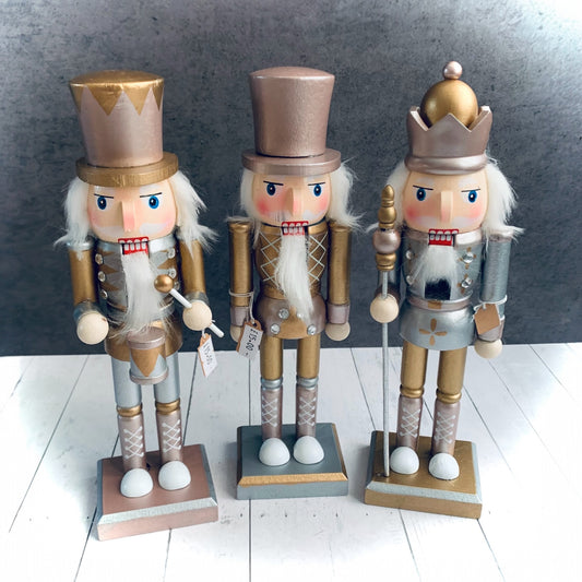 Trio of sugar plum Nutcracker soldiers in different designs. They are pink and gold and are from Wickerhearts Christmas gift collection.