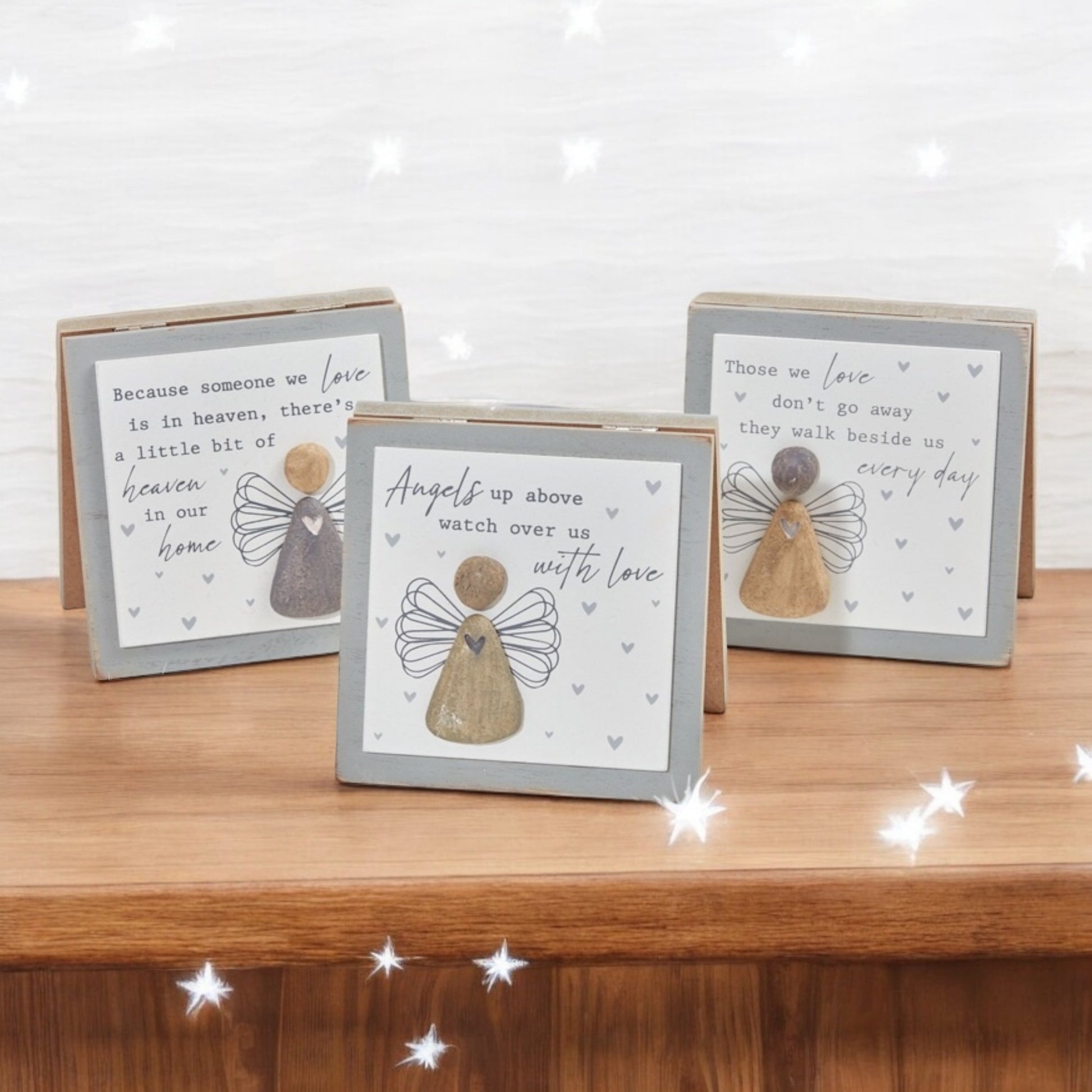 3 separate grey and white wooden memorial pictures, featuring a pebble angel and sentimental wording on each one, making an ideal gift. From the Autumn and Christmas gift collection at Wickerhearts.