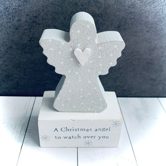 Close up image of wooden grey and white Christmas Angel on block with words 'A Christmas Angel to watch over you'. From Wickerhearts Christmas gift collection.