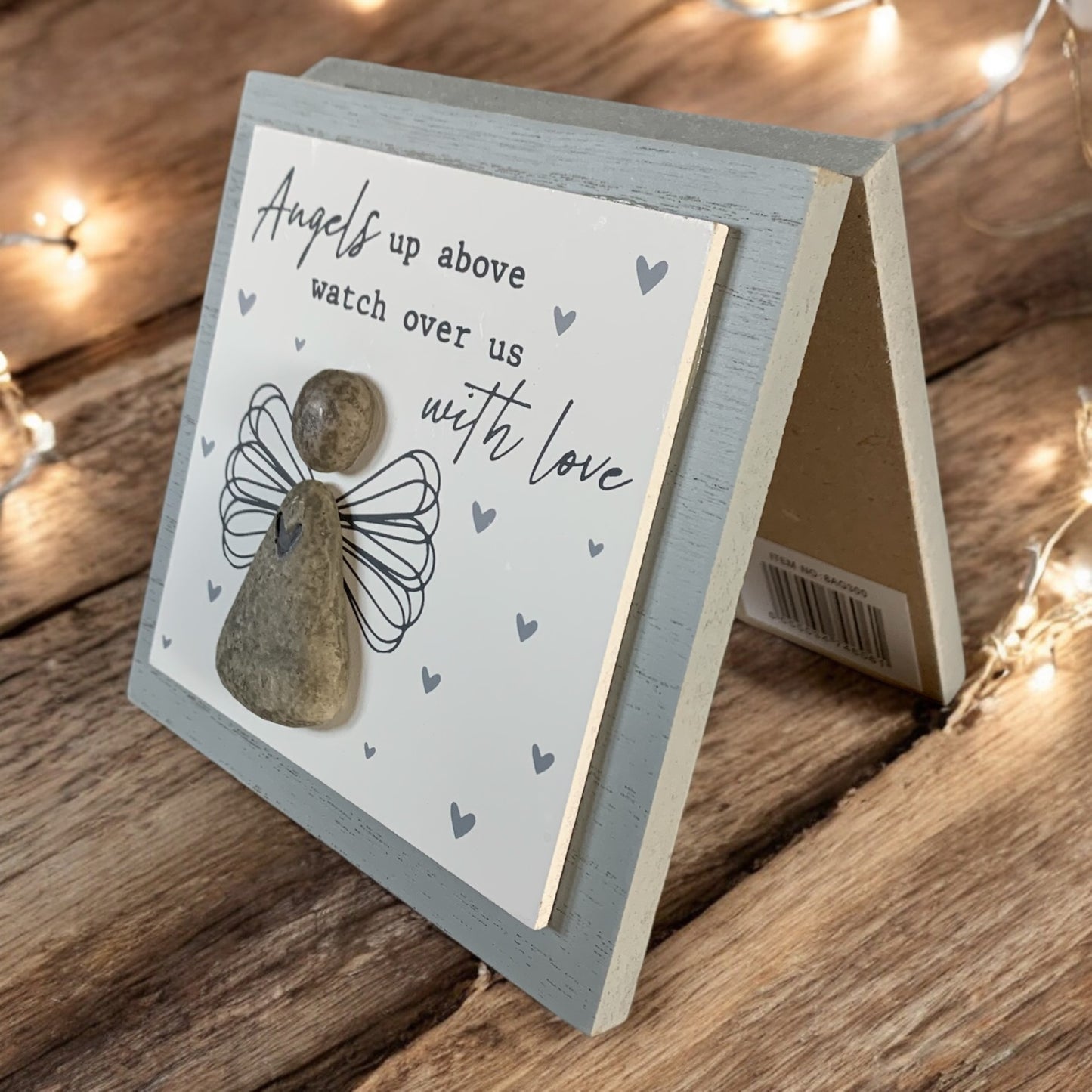 Side image of wooden memorial picture featuring a pebble angel with the words 'Angels up above watch over us with love.' From the Autumn and Christmas gift collection at Wickerhearts.